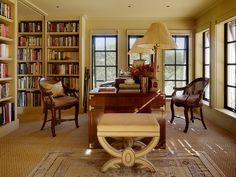 a living room filled with furniture and lots of books