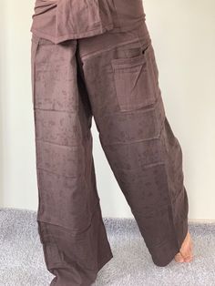 "Unisex Thai fisherman pants. One size fits all. You can wear in many occasions, casual wear, yoga wear, relax at home, travel etc. If you are looking for some pants that you can wear everywhere, comfortable, relax and Easy to wear. Thai fisherman pants is Answer!! Nice gift for yourself or your lover One pocket on the side for storing your items such as wallets, mobile phones, etc Approx. Measurements: One size can fits most and 1 Pockets Waist around 51\" (Wrap Pants) Length 45\" Lower Leg 14\ Brown Bottoms With Hip Pockets, Casual Brown Yoga Pants, Brown Wide Leg Harem Pants With Side Pockets, Brown Wide-leg Harem Pants With Side Pockets, Traditional Wide Leg Bottoms With Elastic Waistband, Brown Pants With Side Pockets, Traditional Wide Leg Pants With Pockets, Traditional Wide-leg Pants With Pockets, Brown Harem Pants With Elastic Waistband