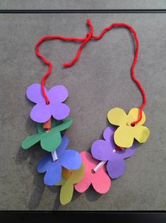 paper flowers are attached to a string