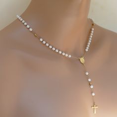 Elevate your spiritual style with our stunning Rosary Necklace with Gold Chain and Elegant Pearl Beads. Made with the utmost care and attention to detail, this unique piece of religious jewelry is the perfect way to showcase your faith in style. Crafted with beautiful artificial pearl beads and a stunning gold plated chain, this rosary . It's comfortable to wear and perfect for layering with your other favorite necklaces. Whether you're dressing up for a special occasion or looking for an everyd Spiritual Single Strand Pearl Necklaces, Spiritual Pearl Chain Jewelry With Round Beads, White 8mm Beads Jewelry For Anniversary, Dainty 8mm Beads Jewelry Gift, Small Beaded Dainty Jewelry Gift, Dainty 8mm Bead Jewelry Gift, Spiritual Pearl White Jewelry For Gifts, Spiritual Pearl Drop Necklace In Pearl White, Spiritual Pearl White Jewelry Gift