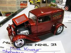 an old model red truck on display at a car show