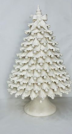 a white ceramic christmas tree sitting on top of a table