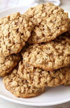 several oatmeal cookies on a white plate