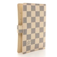 This is an authentic LOUIS VUITTON Damier Azur Small Ring Agenda Cover. This stylish agenda is finely crafted of blue and ivory Louis Vuitton signature checkerboard coated canvas. The agenda has a crossover strap that unsnaps to an ivory cross-grain leather interior with card slots, patch pockets, pen loop, gold rings for inserts, and a Louis Vuitton ruler insert. Agenda Cover, Small Ring, Louis Vuitton Damier Azur, Small Rings, Leather Interior, Authentic Louis Vuitton, Ruler, Louis Vuitton Damier, Crossover