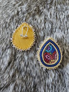 These gorgeous blue and gold beaded earrings are the perfect accessory for your next ceremony, powwow, or for every day wear! Made with size 11 Miyuki beads and backed in deer hide. Centers are kokum scarf fabric and expoxy. Due to the nature of this product, I cannot accept refunds or exchanges. Please message me directly if you have any questions. Artisan Multicolor Beaded Earrings With Gold Beads, Traditional Multicolor Beaded Earrings With Gold Beads, Bohemian Beaded Teardrop Earrings For Party, Gold Beaded Festival Earrings, Gold Teardrop Earrings With Colorful Beads, Handmade Blue Bohemian Clip-on Earrings, Artisan Gold Beaded Earrings, Bohemian Party Earrings With Tiny Beads, Gold Beaded Drop Earrings For Festivals