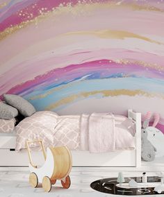 a child's bedroom decorated in pink, blue and gold with an abstract wall mural