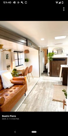 a living room filled with furniture next to a kitchen