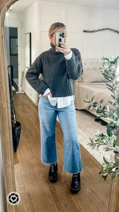 What I wore to work as a teacher in the snow. Loving these cropped wide leg jeans bc the hem stays dry and my weatherproof laguna boots were perfect for the wet snow and sleet. Layer a chunky turtleneck over a white button and pull the hair back in a slick messy bun for a more polished look. Add chunky gold hoops to dress it up and throw on a black overcoat! Medium sweater and button down, tts jeans Follow my shop @emma_grace_blog on the @shop.LTK app to shop this post and get my exclusive app-only content! #liketkit #LTKstyletip #LTKworkwear #LTKmidsize @shop.ltk #chunkyknit #winteroutfit #widelegjeans #casualstyle https://liketk.it/4t0LP Turtleneck Sweater Layering, Bus Casual Outfits For Women, Button Down With Turtleneck, Casual Combat Boots Outfit Jeans, How To Style Low Top Doc Martens, Wide Leg Jeans Ankle Boots, Cropped Green Sweater Outfit, Cropped Flare Jeans Outfit Winter Casual, Cropped Jeans With Boots Winter