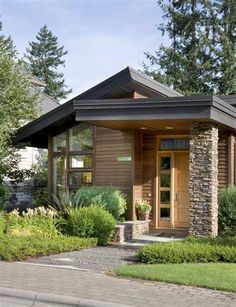 a small house with stone and wood accents