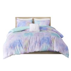 an image of a bed with blue and purple comforter set on top of it