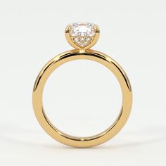 a yellow gold ring with a heart shaped diamond