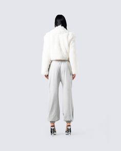 When the fit is not only comfy, but a major slay 😮‍💨​ Turn your off days into a little more with this ivory faux fur coat, white jersey cropped tank, and grey sweatpant set 🙌🏼 Chic Winter Loungewear Sweatpants, Cozy White Sweatpants For Winter, Trendy White Winter Sweatpants, Trendy White Sweatpants For Winter, Fur Coat White, Fuzzy Skirt, White Corset Dress, Denim Pleated Skirt, Parachute Pant