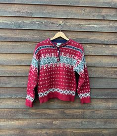 *Please read the entire description before purchasing!* Really great vintage LL Bean festive sweater for holiday and chilly winter weather. Traditional Nordic-style motif in red, gray, white and black. In very good vintage condition with a little bit of loss of elasticity in the ribbed cuffs and hem, but still in great condition with a lot wear left. A lot of nice details and perfect for the holidays and beyond. Sizing: Men's medium, please refer to measurements for an accurate fit. SPECIAL NOTES: *Vintage LL Bean 1980s/1990s pullover sweater *Silver-tone ornamental buttons *Wool/Nylon blend *No stains, rips or holes *Color may vary with different screens Measurements : Bust/Chest (armpit to armpit): 20.5" Length (highest shoulder point to hem): 23" Waist (across the front): 20" Shoulder W Cozy Holiday Sweater With Fair Isle Pattern, Cozy Fair Isle Pattern Sweater For Holidays, Cozy Fair Isle Sweater For Holiday, Vintage Red Sweater For Winter, Red Vintage Knitted Sweater, Retro Long Sleeve Christmas Sweater, Red Vintage Sweater For Winter, Retro Fair Isle Pattern Winter Tops, Vintage Red Knitted Tops