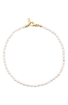 Accessorize with the timeless sophistication of this single-strand anklet showcasing a stream of lustrous freshwater pearls. 10 1/2" length Lobster clasp closure Pearl size: 2mm Freshwater pearl/18k-gold plate Imported Small Pearl Bracelet, Elegant White Anklets With Pearl Chain, Elegant White Pearl Chain Anklets, Proposal Outfit, Anna Aesthetic, Pjo Oc, Pearl Jewlery, Dainty Pearl Bracelet, Hoco 2024