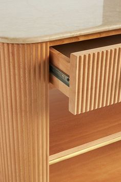 a close up of a wooden cabinet with two drawers and one drawer open on the side