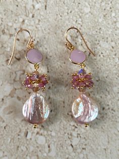 Pearl Earrings featuring a 14MM iridescent pink pearls accented with Swarovski 6MM crystals, dainty pink opal clusters and a pear shape faceted pink chalcedony bezel.  Gold filled lever back ear wires.  Earrings measure 2 3/4 inches. Handmade GIFT BOXED Feminine Pink Pearl Drop Earrings, Pink Teardrop Pearl Earrings For Formal Occasions, Elegant Pink Teardrop Pearl Earrings, Pink Teardrop Pearl Drop Jewelry, Pink Round Pearl Earrings For Formal Occasions, Pink Round Pearl Earrings For Formal Events, Feminine Pink Jewelry With Pearl Drop, Feminine Pink Pearl Drop Jewelry, Elegant Pink Beaded Earrings For Gift