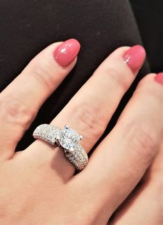 a woman's hand with two engagement rings on it