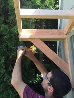 a man is working on an outdoor structure