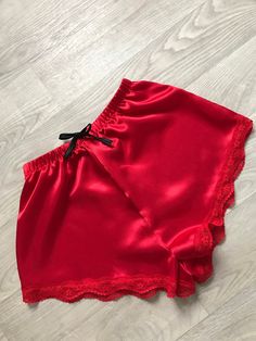 Red silky satin high waisted shorts with lace trim and black tie. Handmade to order. Can also be made in normal length which sit on the hips. (Please write this in the notes when ordering if you would like this style instead) Please feel free to message me with any questions. Red Satin Summer Bottoms, Red Satin Bottoms For Summer, Red Satin Party Bottoms, Red Satin Bottoms, Summer Satin Bottoms With Lace Trim, Red Lace Trim Summer Bottoms, Sleep Clothes, Sleep Shorts, Satin Pajamas