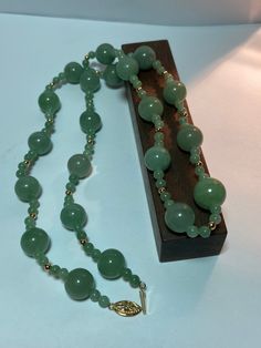 This is a beautiful, vintage, natural, genuine 14K yellow gold, green jade and 14K gold beads necklace. The necklace is about 25 1/2 inches.  The necklace is so unique and features large, natural, round green jade that is 13mm (about 1/2" in diameter) then there are 2 smaller, natural, round green jade that are 5mm (about 3/16" in diameter) separated with a 14K yellow gold bead that is about 1/8" in diameter. So there are 4 smaller green jade balls and 1 14K yellow gold bead between each of the larger green jade balls. The high-quality jade is a gorgeous green color. Just stunning and very well-made. The necklace has a secure 14K slide clasp that is ornate with a flower on it. The necklace weighs an impressive 58.2 grams. It is marked 14K WW. I am unsure who the artisan is who uses that ha Swamp Princess, Gold Beads Necklace, Vintage Navajo Jewelry, Green Jade Necklace, Tibetan Jewelry, Real Gold Jewelry, Navajo Jewelry, Gold Bead Necklace, Jade Necklace