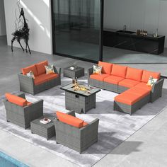 an outdoor living room with grey and orange furniture