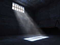 an empty room with sunlight coming through the window and beam of light on the floor