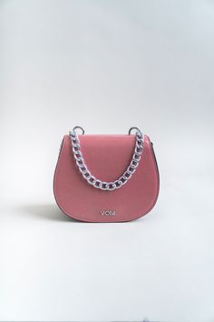 Who says pink can't be edgy? You'll love to make others blush with this stunning handbag. Carry it for a fashionable outing and let it do all the talking. Finished with this season's statement eyelets, this beauty can be worn over the shoulder with a longer adjustable strap, or in your hand with our chucky short chain. Smooth vegan leather. Attached silver chain accent with silver studs. Fabric lined interior Crossbody design with soft adjustable shoulder strap. Flap with magnetic snap closure. Pink Shoulder Bag With Chain Strap For Everyday, Pink Satchel With Silver-tone Hardware, Pink Top Handle Satchel With Silver-tone Hardware, Trendy Blush Shopping Bag, Trendy Blush Shopping Bags, Trendy Blush Bag For Shopping, Everyday Pink Shoulder Bag With Chain Strap, Trendy Pink Bag With Silver-tone Hardware, Trendy Pink Satchel With Chain Strap