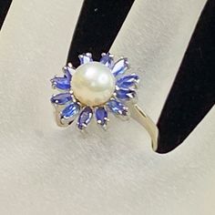 An Elegant Lady 14k White Gold Ring, Circa Approx. C1950-1960's. In The Center Prong Setting One Genuine Cultured Pearl, Lustrous Silver Tone Overtone, It Surrounds With Twelve (12) Natural Ceylon Blue Marquise Shaped Sapphire, 3 X 2.2mm, No Chip Noticeable. The Pearl Has Normal Very Minor Scratches. Ring Top Is 16.0mm Wide, Ring Size 6 3/4, Weight 4.3gm, Hallmark 14k. Cultured Pearl Ring, Ceylon Sapphire, Elegant Lady, Wide Ring, 14k White Gold Ring, The Pearl, White Gold Ring, Marquise Cut, Pearl Ring