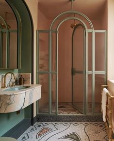 a bathroom with a sink, mirror and shower in it's corner area next to a bathtub