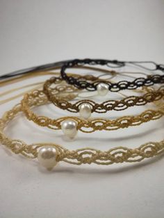 four different types of bracelets with pearls on them