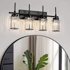 a bathroom vanity light with three lights and a mirror in front of the sink area