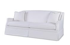 a white couch with two pillows on the back and one pillow that is attached to it