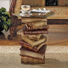 a stack of books sitting on top of a glass table