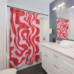 a bathroom with red and white shower curtains