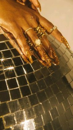 a woman's hand on top of a shiny mirror