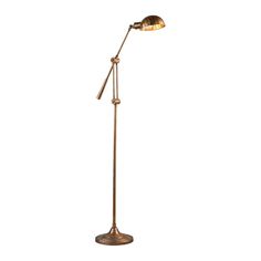 a floor lamp that is on top of a white wall and has a gold colored shade