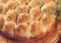 a close up of a bread dish on a wooden platter