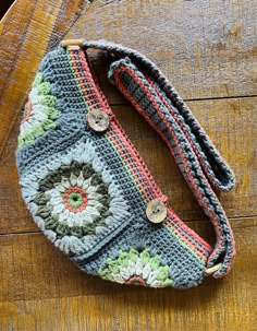 a crocheted purse sitting on top of a wooden table