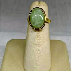 Vintage Jade 14k Solid Hold Oval Cabochon Ring This Beautiful Ring Features A Stunning Oval-Shaped Natural Jade Stone Set In A 14k Yellow Gold Bezel Setting. The Stone Measures 14mm In Length And 10mm In Width, With A Tapering Band Width Of 2.5mm To 1.5mm. The Ring Weighs 2.88 Grams Or 1.85 Dwt. The Authentic Jade Stone Is The Centerpiece Of The Ring, With No Additional Gemstones. Oval Gold Opal Ring In 14k Gold, Yellow Gold Jade Cabochon Ring, Heirloom Gold Emerald Ring With Oval Cabochon, Formal Oval Jade Emerald Ring, Classic Gold Opal Oval Cabochon Ring, Oval Opal Ring In Yellow Gold Stamped 14k, Classic Gold Opal Ring With Oval Cabochon, Gold Emerald Ring With Bezel Setting In Oval Shape, Oval Polished Emerald Ring In 14k Gold