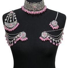 Handcrafted pink silver kundan Indian wedding / bridal jewellery set. Set includes- Earrings with multilayer pearl sahara  Choker necklace Jhumar Tikka  Our choker is adjustable with a dori at the back giving you a comfortable fit. It comes with elegant kundan earrings with pearl detail, tikka and jhumar with hooks.  The subtle glimmer of the kundan with elegant pearl detail makes this jewelry set a truly head turning piece, a must have for every jewellery box.  Our ethnic jewellery set harmonio Pink Meenakari Bridal Necklace For Party, Silver Tilla Choker For Reception, Silver Meenakari Choker Jewelry Sets, Pink Stone Work Necklaces For Party, Pink Stone Work Necklace For Party, Silver Embroidered Choker For Reception, Silver Kundan Lehenga For Wedding, Bollywood Style Pink Bridal Necklace For Reception, Silver Bridal Set With Tilla For Festivals