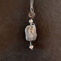 Grey botswana Agate nugget with silver wrap; 1" w x 3.5" h incl bail Silver Agate Wire Wrapped Necklace, Silver Wire Wrapped Chalcedony Necklaces, Handmade Tumbled Agate Jewelry, Wire Jewerly, Organic Jewelry, Wire Weaving, Botswana, Beads And Wire, Copper Jewelry