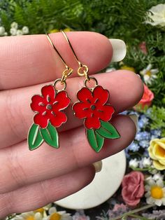 "Red flower earrings with green leaves and golden details. *Length (using default ear hooks): 1.75\"  *Weight (approx, each): 2g ✨Upgradable earring options available are: Gauge sizes are approximate, batches may vary. Some options may be in limited supply and may take additional time to ship.  *304 Steel mini hooks, silver color, 22 gauge (0.7mm). This is the perfect option for anyone with smaller lobes or with low piercings.  *316L Steel hooks, silver color, 21 gauge (0.8mm).  *Golden steel ho Red Flower Drop Earrings, Red Flower Earrings With Ear Wire For Gift, Flower Shaped Earrings With French Hook For Gift, Red Dangle Earrings With Flower Charm, Red Flower Charm Earrings, Red Drop Earrings With Flower Charm, Flower-shaped Earrings With French Hook As Gift, Red Earrings With Flower Charm For Gift, Red Flower Earrings With Ear Wire