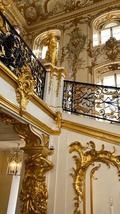 an ornate gold and black staircase in a building