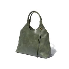 A green tote bag with a 1970's silhouette handcrafted from sustainable leather and lined with 100% Ethiopian cotton. Rectangular Hobo Bag With Brass Hardware For Travel, Green Shoulder Bag With Palladium Hardware For Everyday, Everyday Rectangular Hobo Bag With Brass Hardware, Rectangular Hobo Bag With Brass Hardware For Everyday, Elegant Rectangular Hobo Bag With Brass Hardware, Vintage Hobo Bag With Detachable Handle For Everyday, Versatile Shoulder Bag With Brass Hardware For Everyday Use, Travel Tote Hobo Bag With Brass Hardware, Travel Hobo Tote Bag With Brass Hardware