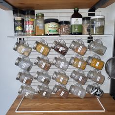 the spice rack is organized with jars and spices