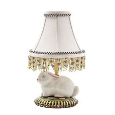 a white rabbit lamp sitting on top of a table