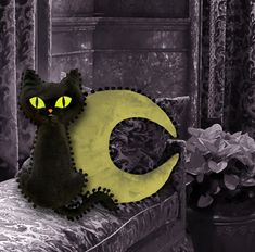 a black cat sitting on top of a couch next to a yellow crescent sign with glowing eyes