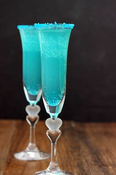 two champagne flutes with blue liquid in them