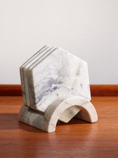 a marble sculpture sitting on top of a wooden table