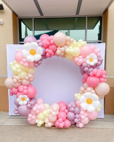 a wreath made out of balloons and flowers